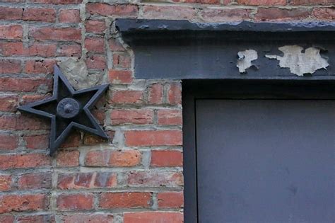 meaning of metal star on houses|cast iron stars on buildings.